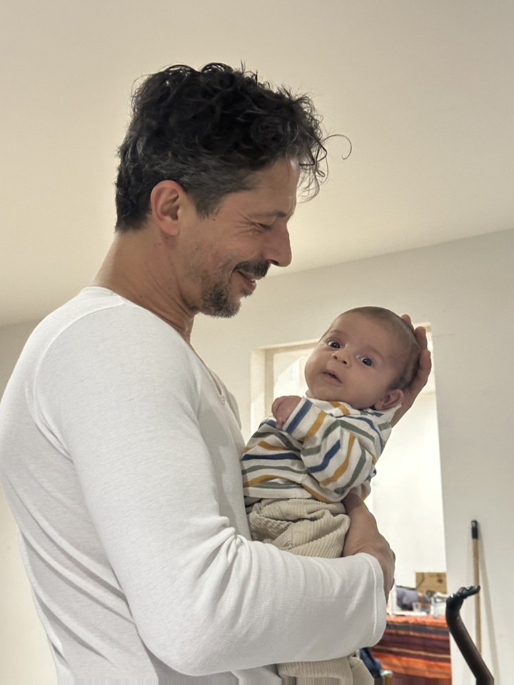 Avant : un papa tient son bébé, photo prise au téléphone à la maison